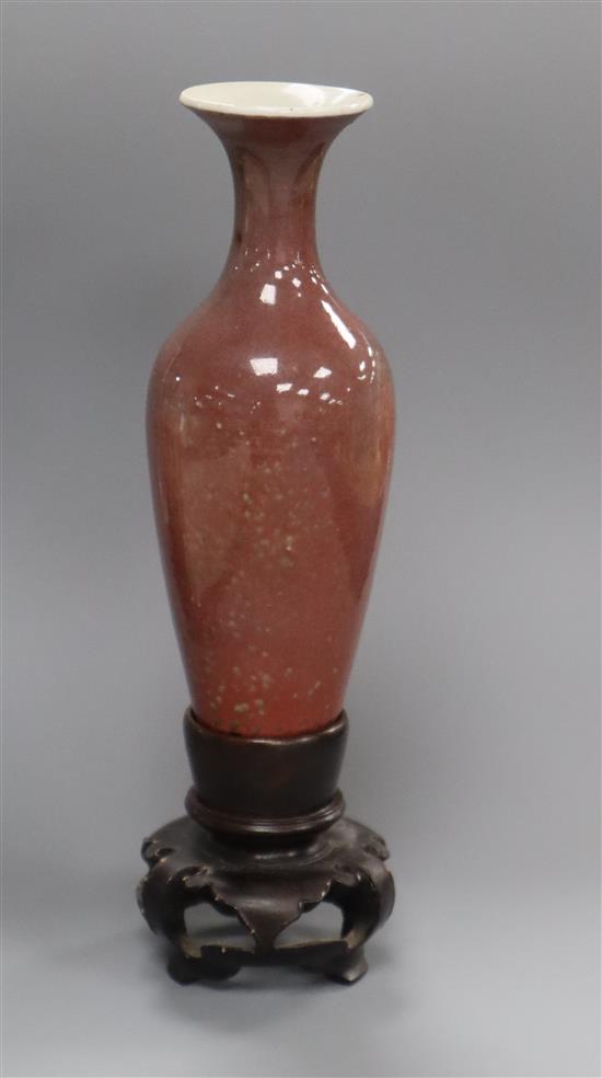 A Chinese sang de boeuf glazed small vase, Kangxi mark but Republic period, H. 18.5cm including wood stand